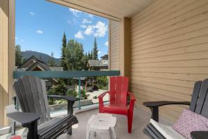 two chairs and a table on a balcony with a view at The Snowbird by Whiski Jack in Whistler