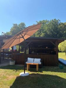 a large umbrella on a table in the grass at Green River - robinzonski kamp in Duga Resa