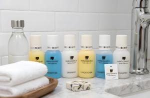 a group of bottles of cleaning products on a counter at Senator panoramic Hotel in Baku +25 photos