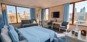 a hotel room with a large bed and a view of the city at Senator panoramic Hotel in Baku