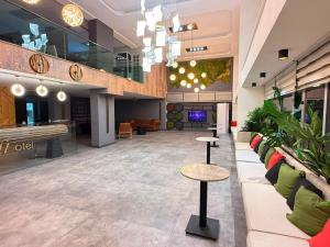 a lobby with couches and tables in a building at Ayseli Hotel in Mersin