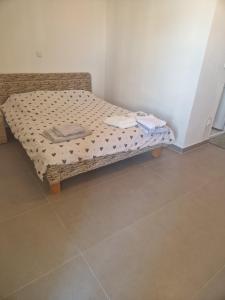 a small bed in a corner of a room at Appartemani EMIE in Donji Štoj +3 photos