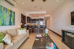 a living room with a couch and a table at 360 Splendor 306-Ocean View Condo-Breakfast in Playa Flamingo