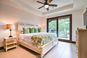a bedroom with a bed and a ceiling fan at 360 Splendor 306-Ocean View Condo-Breakfast in Playa Flamingo +31 photos