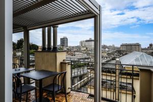 a balcony with tables and a view of a city at Hotel Caffaro in Genoa