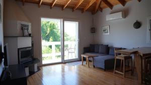 a living room with a couch and a table at Coollyhouse Keklik tepe Urla in Urla