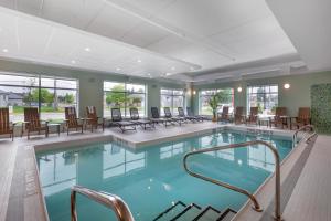 a large swimming pool with chairs and tables in a building at Best Western Plus Kawartha Lakes Hotel & Suites in Lindsay