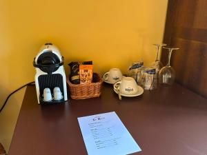 a table with a coffee maker and a basket of food at Hostal La Riera de Peratallada in Peratallada