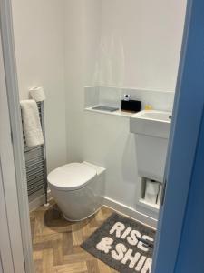 a bathroom with a white toilet and a sink at StaywithusHighbridge in Highbridge