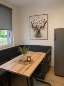 a dining room table and bench with a wooden table at Alpinchalet Eisenerz in Eisenerz +6 photos
