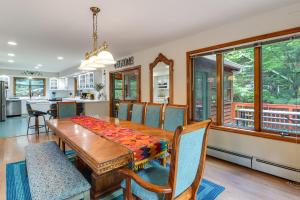 a kitchen and dining room with a wooden table and chairs at Split Rock Resort: Family Getaway w/ Fire Pit! in Lake Harmony