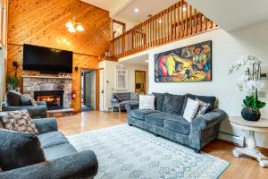 a living room with couches and a fireplace at Split Rock Resort: Family Getaway w/ Fire Pit! in Lake Harmony