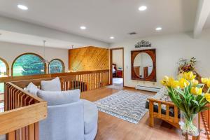 a living room with a couch and a vase of flowers at Split Rock Resort: Family Getaway w/ Fire Pit! in Lake Harmony