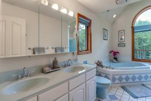 a bathroom with two sinks and a tub and a toilet at Split Rock Resort: Family Getaway w/ Fire Pit! in Lake Harmony +35 photos