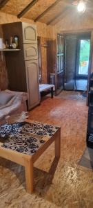 a living room with a coffee table in a room at Planinska kuca Gogo in Kupres +4 photos
