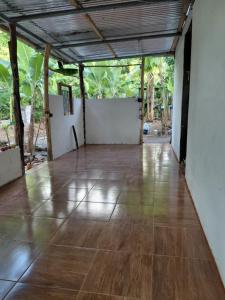 an empty room with a wooden floor and trees at Cabaña Colibrí Balgue in Altagracia