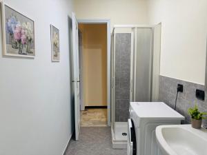 a bathroom with a sink and a toilet and a shower at Station -Mansarda in posizione strategica, vista panoramica, letto king size e clima in Ivrea +14 photos