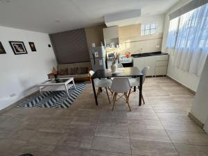 a kitchen and dining room with a table and chairs at San Francisco in Comodoro Rivadavia