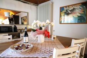 a table with a plate of food and a bottle of wine at Casale del Miglio in Casorzo