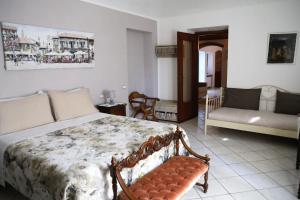 a bedroom with a bed and a couch in it at Casale del Miglio in Casorzo +101 photos