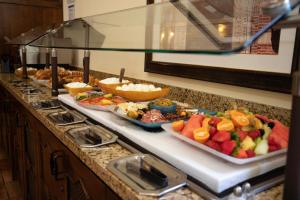 a buffet line with several plates of food on a counter at The Inn at UCLA in Los Angeles