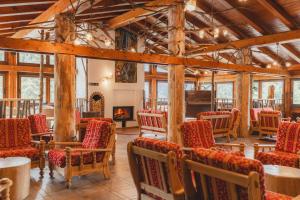 a large room with chairs and a fireplace at Hotel Selva in Folgarida