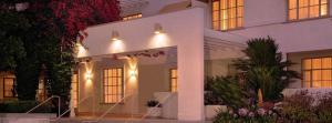 a white house with lights on the front of it at The Inn at UCLA in Los Angeles