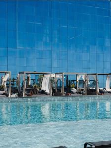 a swimming pool with chairs and a building at Hotel Blue Sea in Itapema +3 photos