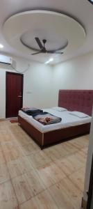 a bed in a room with a ceiling at Hotel Touchwood in Prayagraj