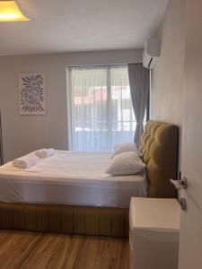 a bedroom with a large bed with a window at The Touch of the Sea in Durrës +31 photos