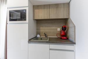 a kitchen with a sink and a red appliance at Sea lounge in Varna City +124 photos