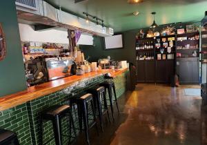 a bar in a restaurant with bar stools at Aiden Hotel Sacramento Downtown in Sacramento