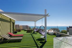 a patio with chairs and swings on a roof at Sea lounge in Varna City