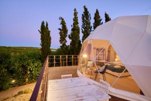 a large white tent with a table and chairs at Geo heaven glamp in Aïtánia