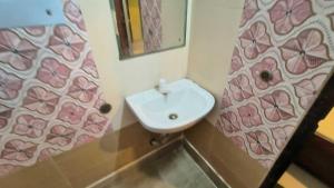 a bathroom with a sink and a mirror at Hotel O Krishna Bhawan in kolkata