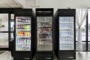 two refrigerators with drinks in them in a store at Studio 6 Suites Jacksonville, NC - Camp LeJeune in Jacksonville