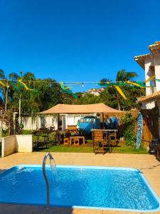a swimming pool in the backyard of a house at Piratas Guest Rooms II in Búzios