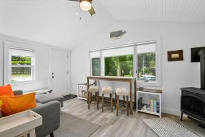 a living room with a couch and a table at Bed, Splash Beyond – Coastal Comfort Awaits in Orleans +18 photos