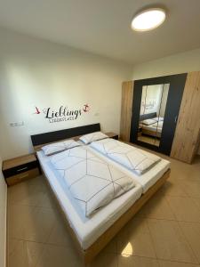 a bed in a room with a sign on the wall at Lieblingsplatz in Pfullendorf