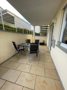 a patio with a table and chairs on a balcony at Lieblingsplatz in Pfullendorf