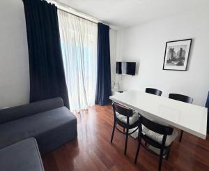 a living room with a table and chairs and a couch at Moro Crikva in Crikvenica