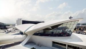an airport building with a white roof and windows at TWA Hotel at JFK Airport in Queens