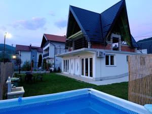 a house with a swimming pool in front of it at A&H Pliva Retreat in Jajce