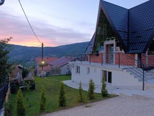 a house with a solarium on the side of it at A&H Pliva Retreat in Jajce