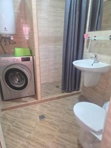 a bathroom with a washing machine and a sink at Apartments Dani in Pomorie +129 photos