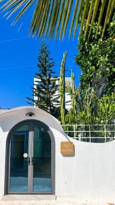 a door to a house with a palm tree at Sosun View Private Villa in Thoddoo