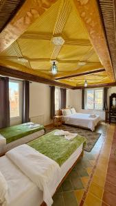a large room with three beds in it at Hotel New Mars Dades in Aït Idaïr +98 photos