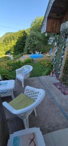 a group of chairs and tables on a patio at Vikendica Iris in Mojkovac