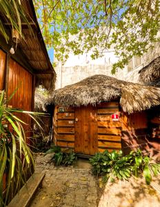 a wooden hut with a thatched roof at Raiz Kite Cabana in Jericoacoara