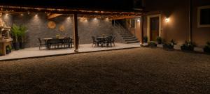 a patio with a table and chairs at night at Harmony apartment near Dassia, Ipsos in Ipsos +3 photos